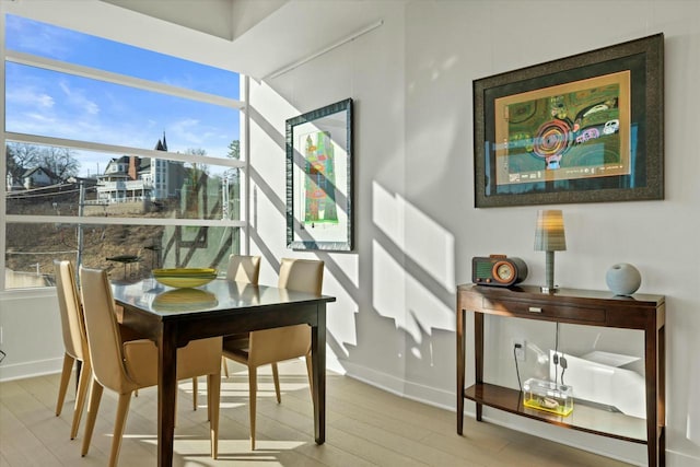 dining area with wood finished floors and baseboards