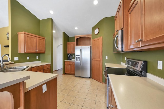 kitchen featuring a sink, open shelves, stainless steel appliances, light countertops, and light tile patterned floors