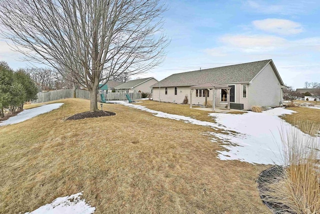 exterior space featuring fence and a lawn