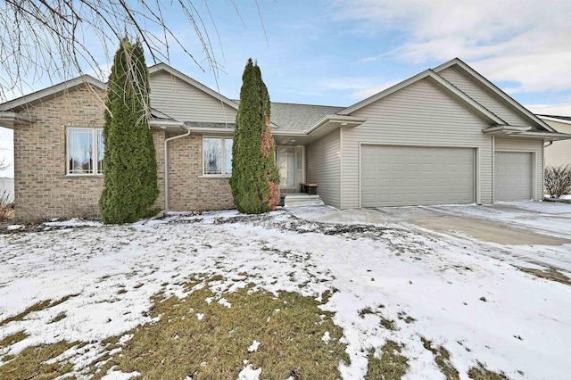 single story home featuring an attached garage, brick siding, and driveway