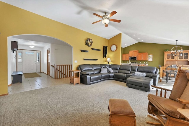 living room featuring lofted ceiling, light tile patterned flooring, arched walkways, light carpet, and a chandelier