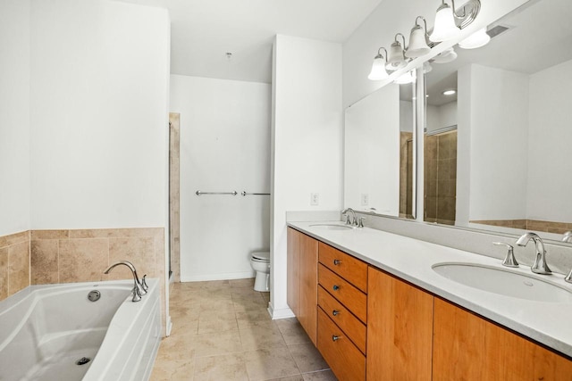 bathroom with a sink, toilet, a bath, and tile patterned floors