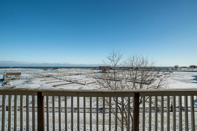 wooden terrace featuring a water view