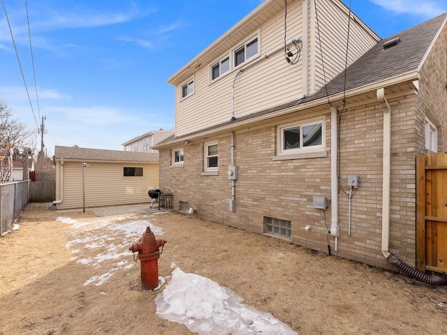 rear view of property with brick siding and fence private yard