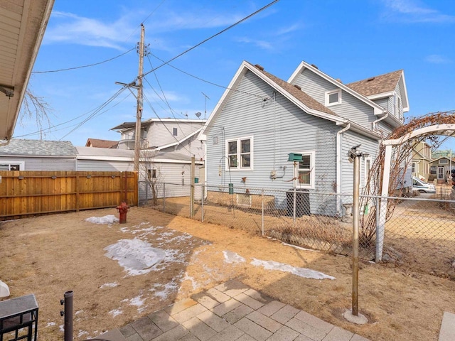 rear view of property featuring fence private yard