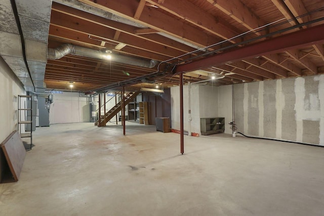 unfinished below grade area featuring water heater, stairway, and heating unit