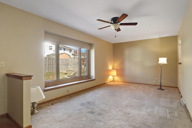 unfurnished room with carpet flooring, visible vents, and baseboards