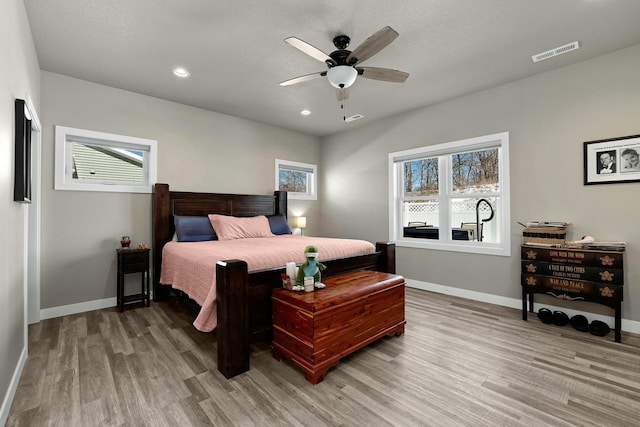 bedroom with recessed lighting, visible vents, light wood-style flooring, and baseboards