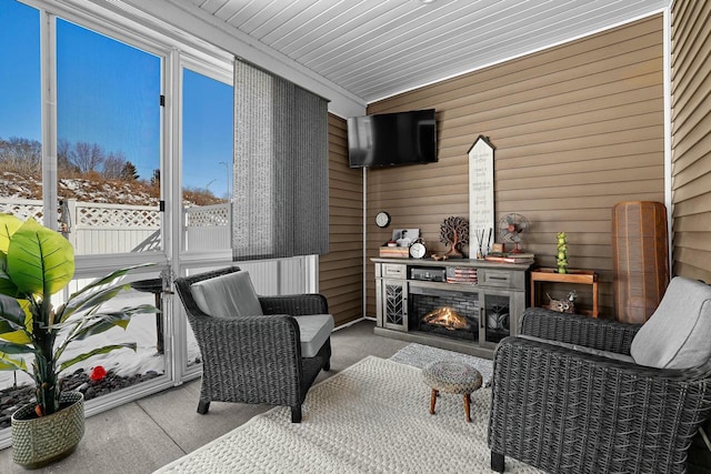 sunroom with a warm lit fireplace