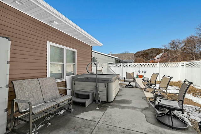 view of patio / terrace featuring a fenced backyard and a hot tub