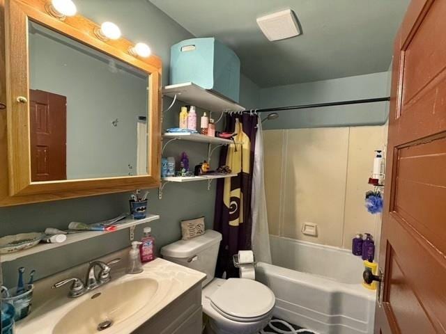 bathroom featuring vanity, toilet, and shower / tub combo with curtain