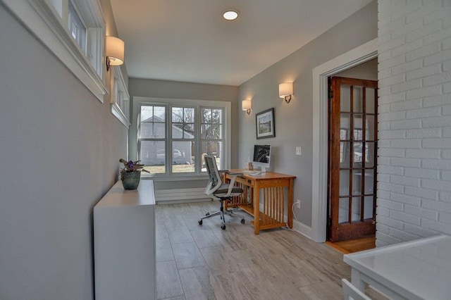 home office featuring baseboards and wood finished floors