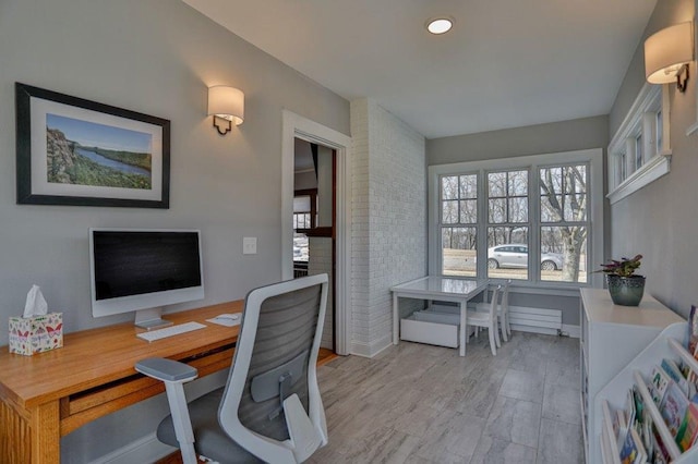 home office featuring baseboards and light wood-style floors