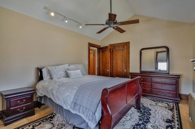 bedroom featuring lofted ceiling, wood finished floors, a ceiling fan, and radiator heating unit