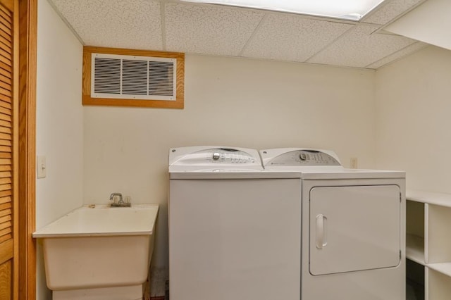 laundry room featuring laundry area, a sink, visible vents, and separate washer and dryer