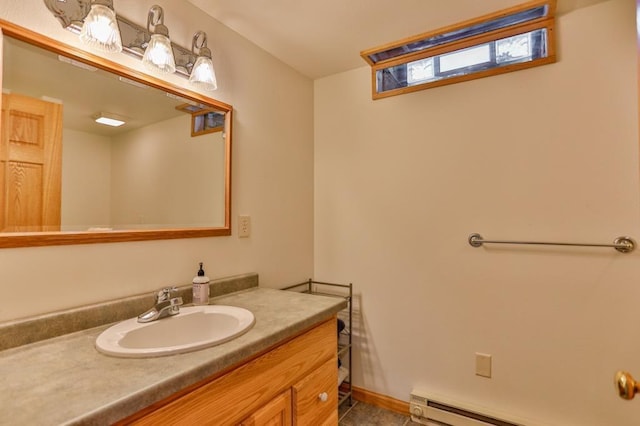 bathroom with vanity, baseboards, and a baseboard radiator