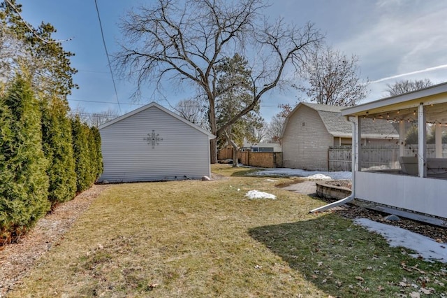 view of yard with an outbuilding and fence