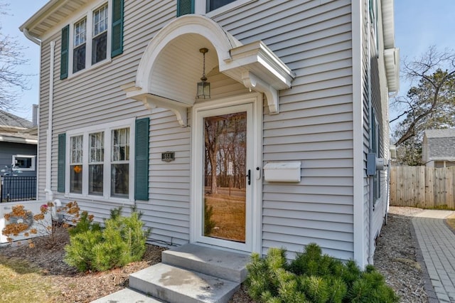 view of exterior entry with fence