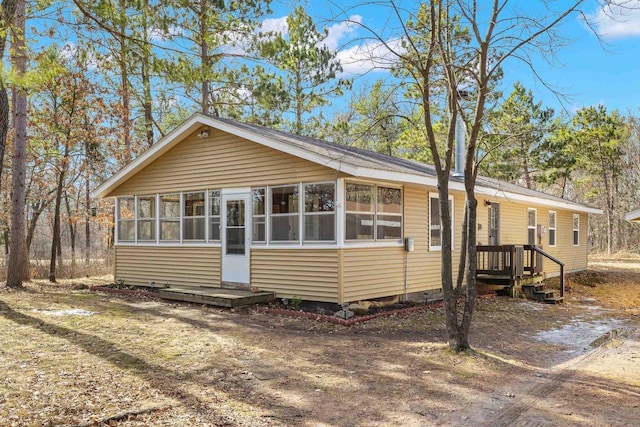 view of front of house featuring a sunroom