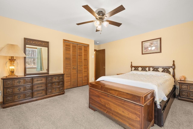 carpeted bedroom featuring a closet and a ceiling fan