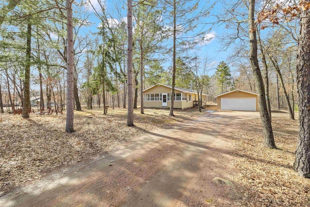 view of front of house featuring a detached garage and an outdoor structure