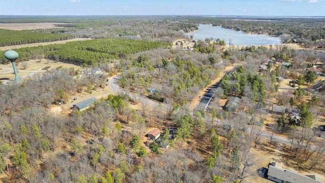 aerial view featuring a forest view and a water view