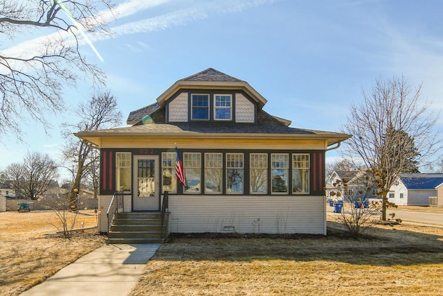 bungalow-style house featuring a front yard