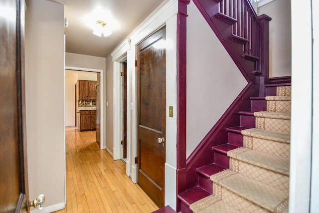 interior space featuring baseboards and wood-type flooring