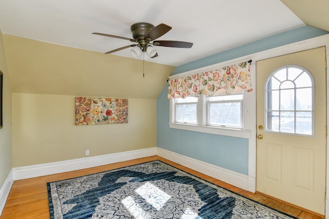 bonus room with lofted ceiling, wood finished floors, baseboards, and ceiling fan