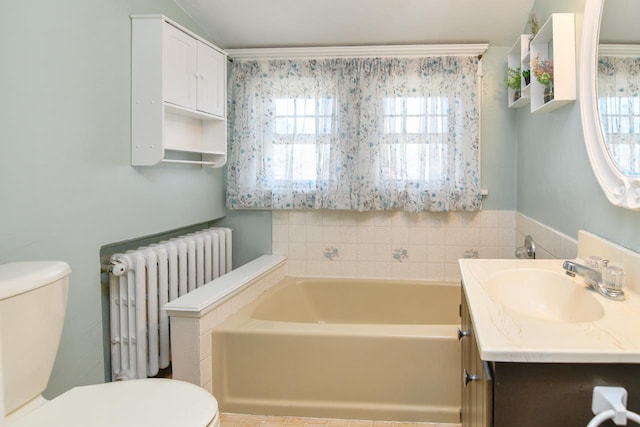 full bath with a wealth of natural light, radiator, toilet, and a garden tub