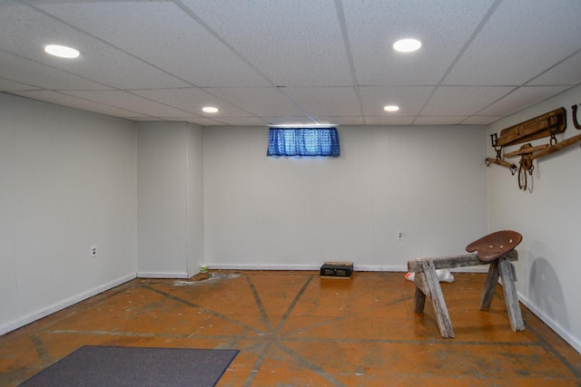 exercise room with recessed lighting, a paneled ceiling, and baseboards