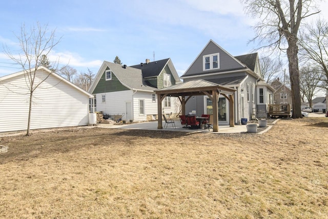 back of house with a gazebo and a patio