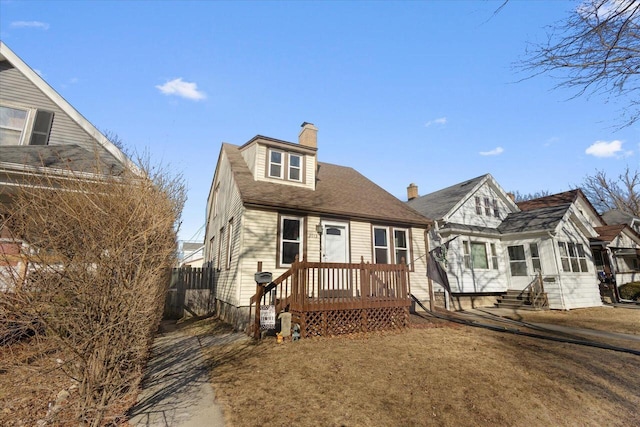 view of front of home with entry steps, a chimney, roof with shingles, and fence