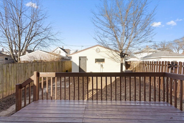 wooden deck with an outbuilding and a fenced backyard