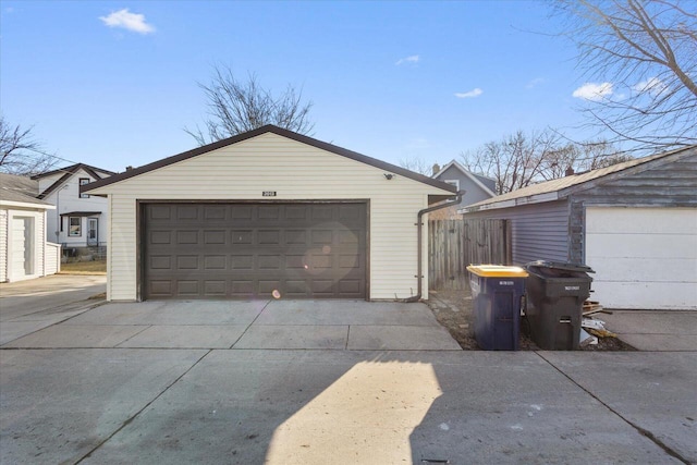 detached garage featuring fence