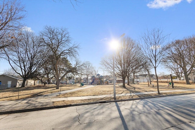 exterior space featuring playground community, a residential view, and fence