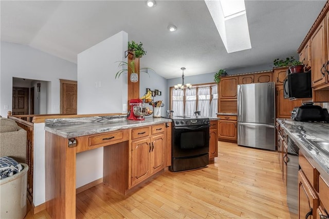 kitchen with dishwashing machine, freestanding refrigerator, electric range oven, black microwave, and lofted ceiling with skylight