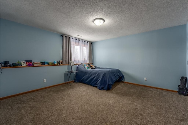 carpeted bedroom with baseboards and a textured ceiling