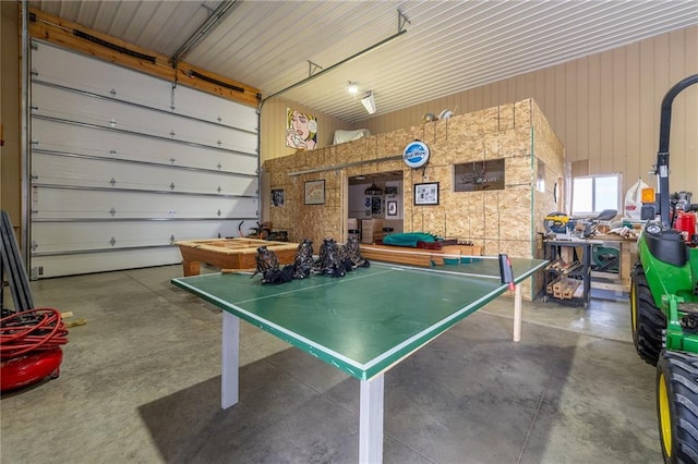 rec room with a garage and concrete flooring