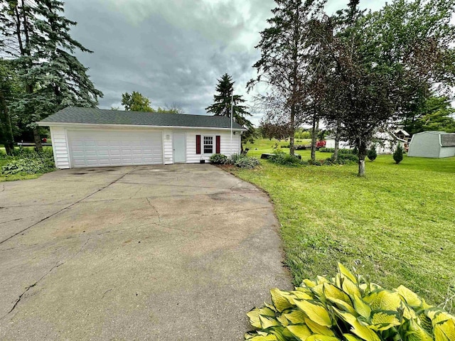 ranch-style home with a garage, driveway, and a front yard