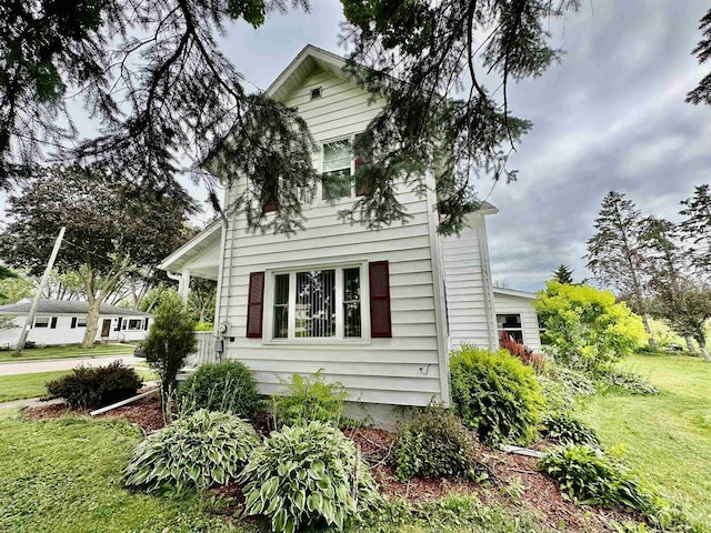 view of home's exterior with a yard