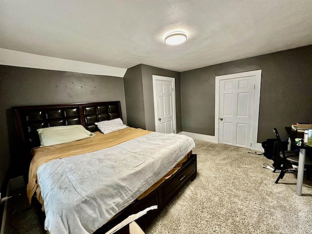 bedroom with baseboards and carpet