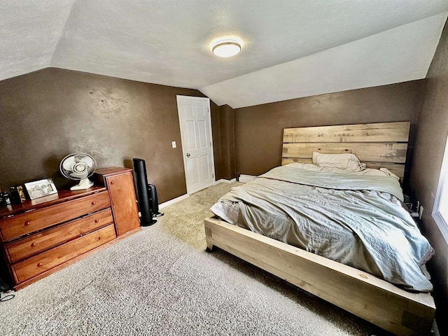 bedroom featuring baseboards, carpet, and vaulted ceiling