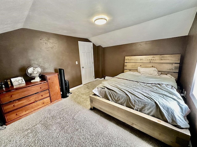 bedroom with baseboards, carpet, and vaulted ceiling