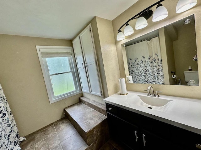 full bath with vanity, tile patterned floors, and toilet