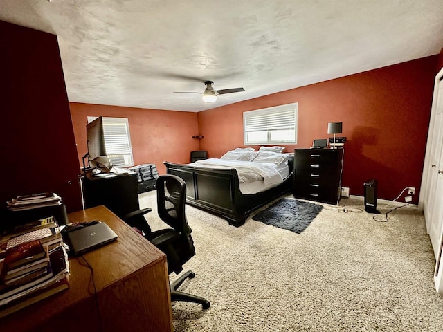 carpeted bedroom with a ceiling fan and baseboards