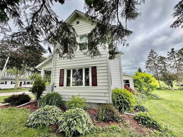 view of side of property with a yard