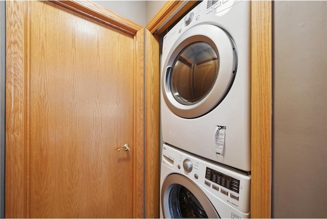 laundry room with stacked washer / drying machine