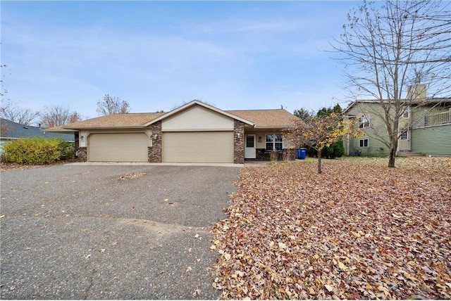 view of front of house featuring a garage, brick siding, and aphalt driveway