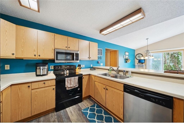 kitchen featuring a sink, lofted ceiling, light countertops, and stainless steel appliances